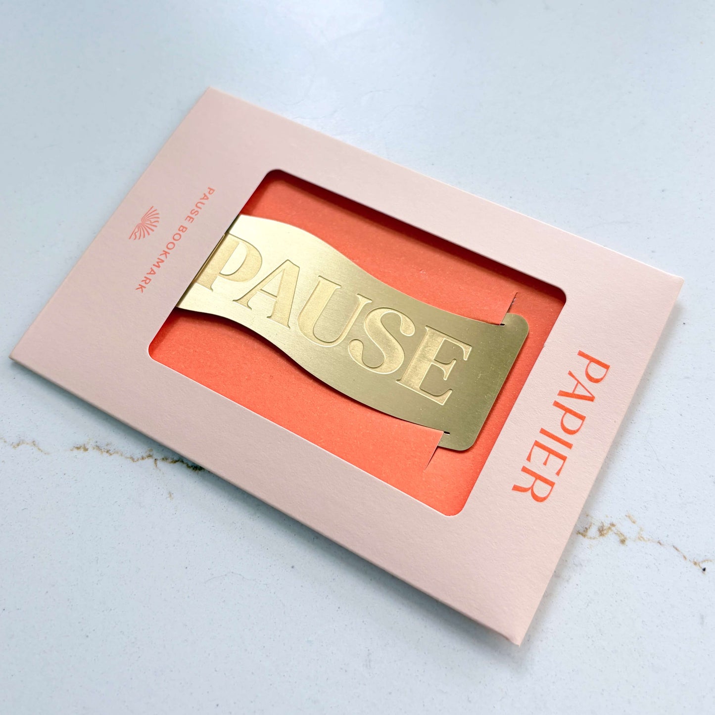Papier Brass 'Pause' Bookmark in its presentation box shown at an angle.