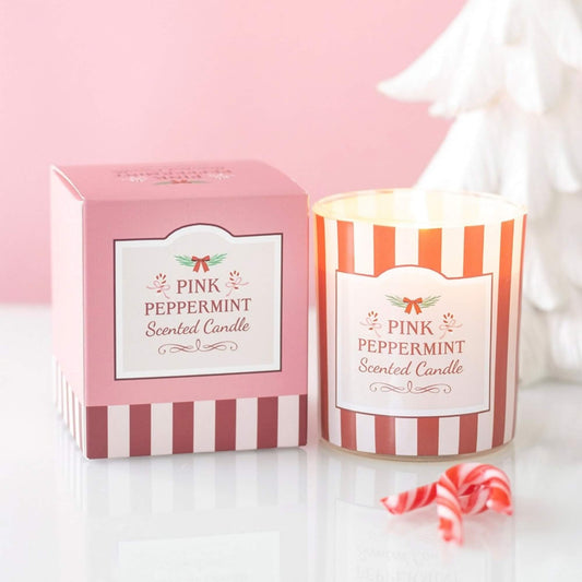 Pink Peppermint scented Christmas candle in red and pink striped glass beside coordinating gift box