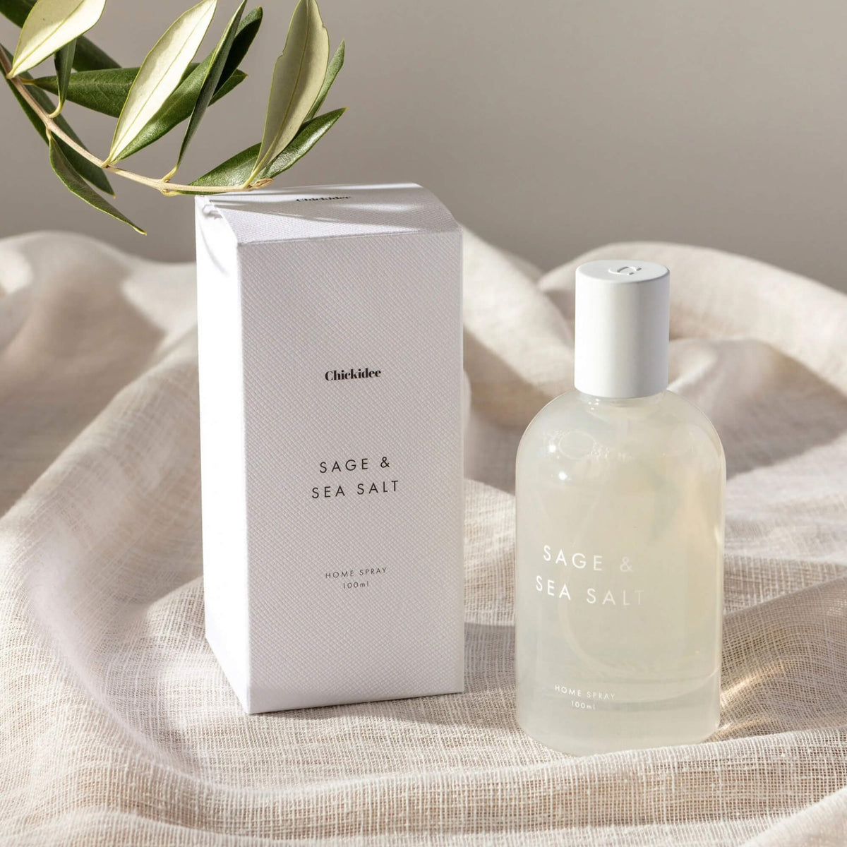 Sage & Sea Salt room spray and textured white presentation box styled on pale fabric