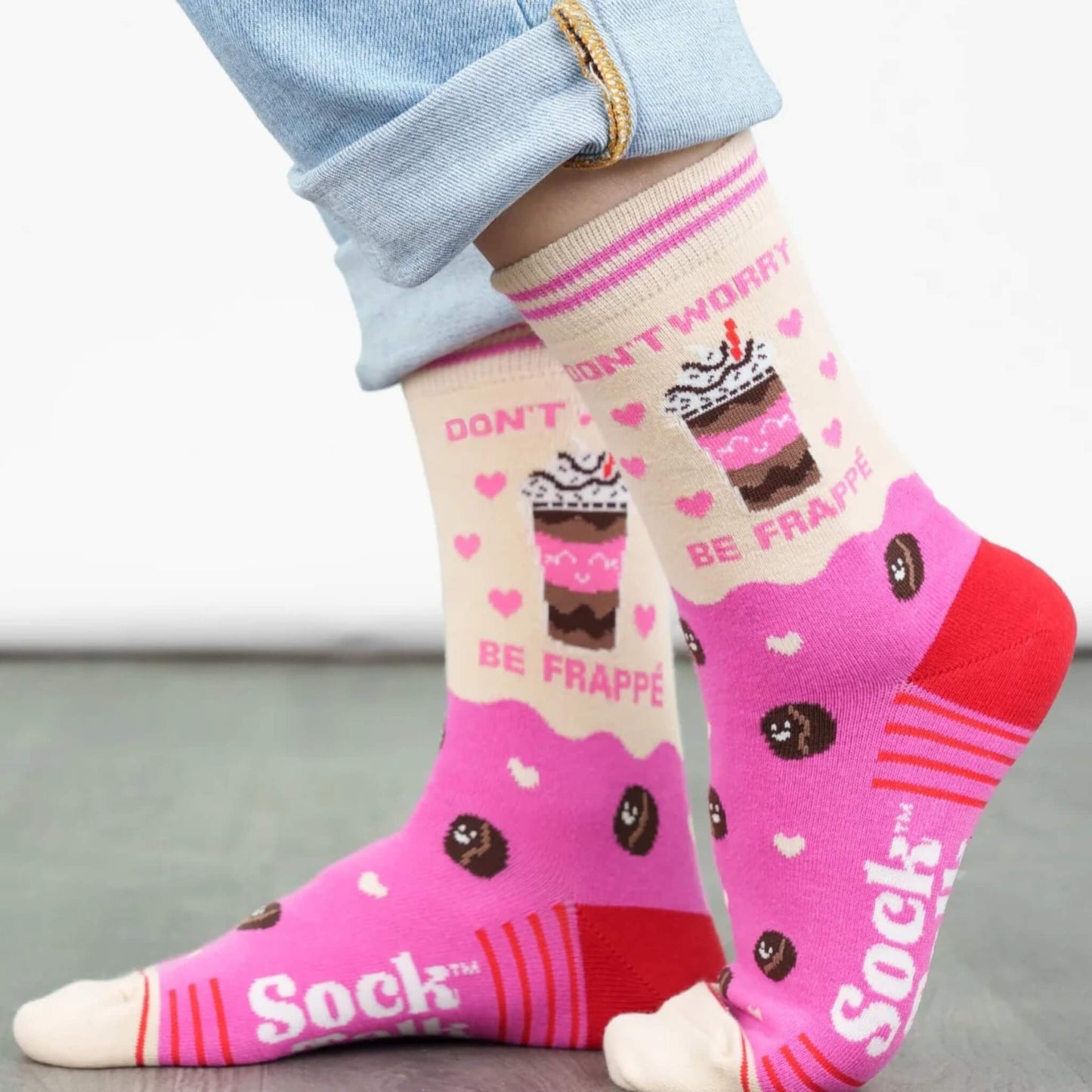 Lifestyle photo of Sock Talk Be Frappe coffee-themed socks being worn, showing the fun coffee cup design and pink accents.