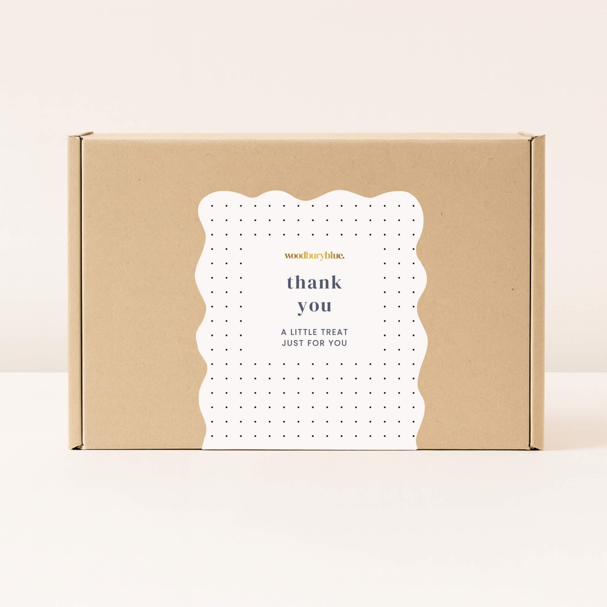 Kraft gift box with white thank you sticker and small black polka dots from Woodbury Blue
