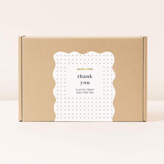 Kraft gift box with white thank you sticker and small black polka dots from Woodbury Blue