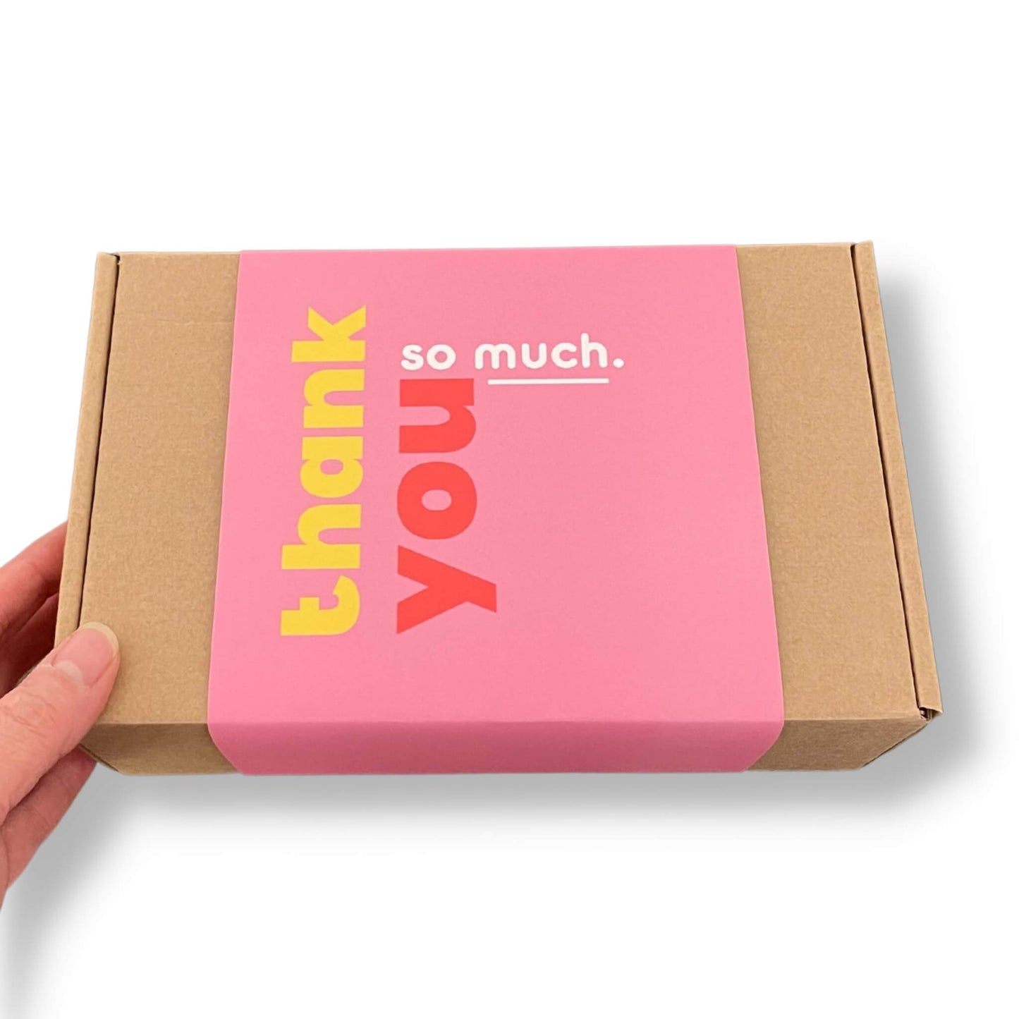 Kraft gift box with a pink sleeve and colourful lettering that says 'thank you so much' on the front