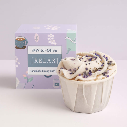 Handmade luxury bath bomb with Wild Olive packaging on a white background