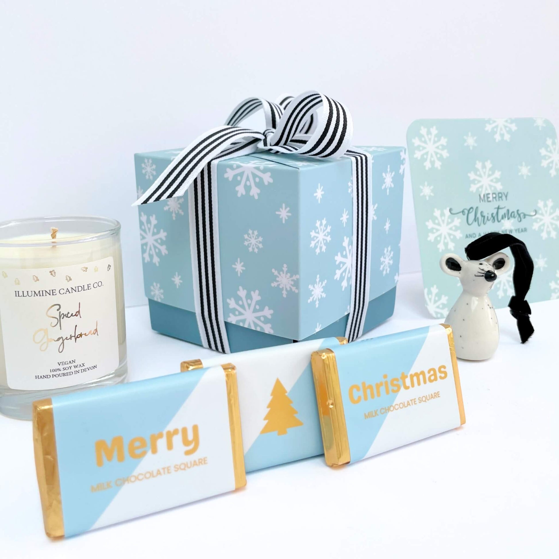Side angle close-up of Winter Glow Christmas Gift Box showing ribboned box and seasonal contents
