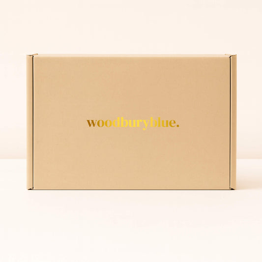 Kraft gift box with simple matt gold Woodbury Blue logo on the front