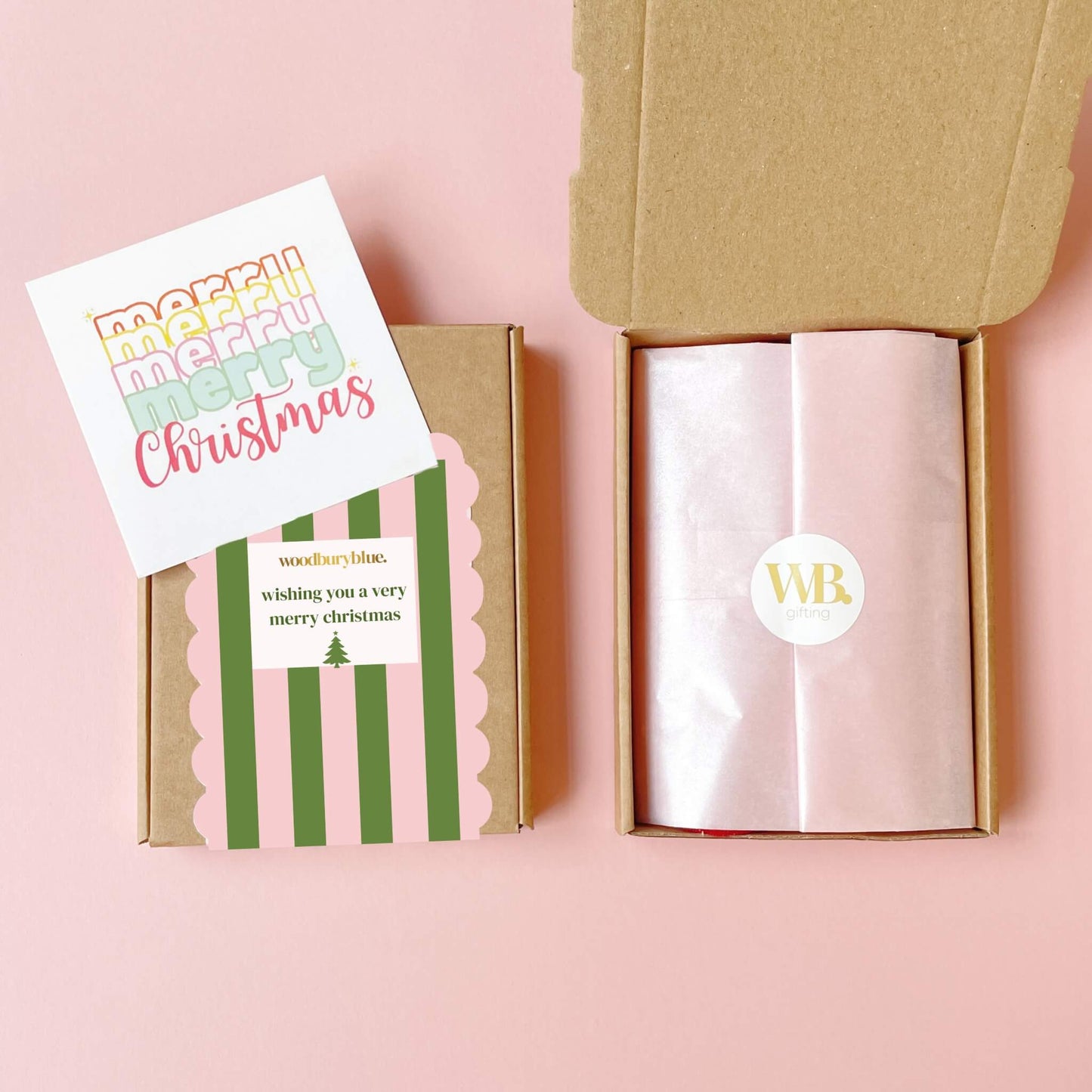 Flat lay of pink and green gift box with christmas notecard and pink wrapping inside