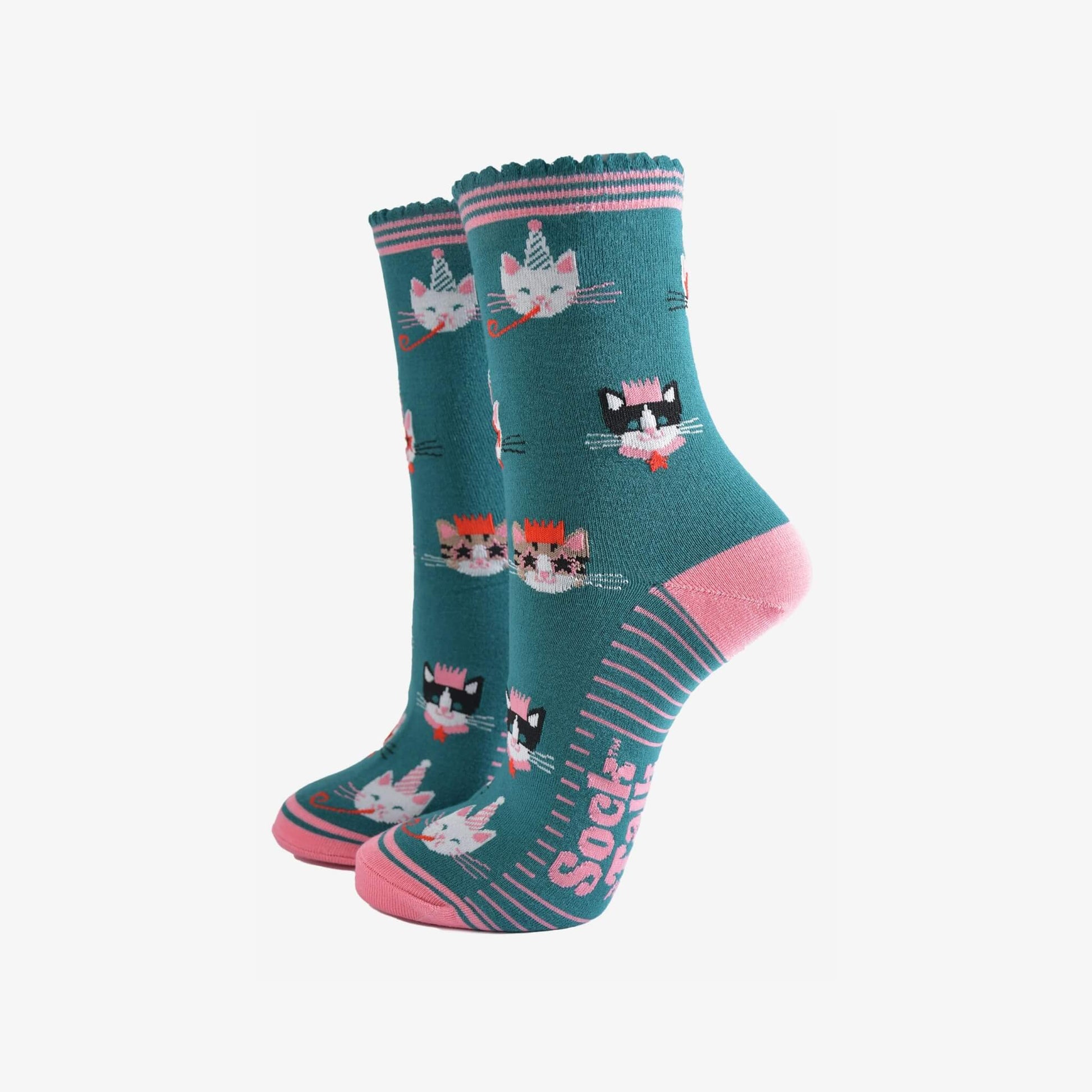 Pair of green and pink Party Cats bamboo socks with birthday cat design from Sock Talk
