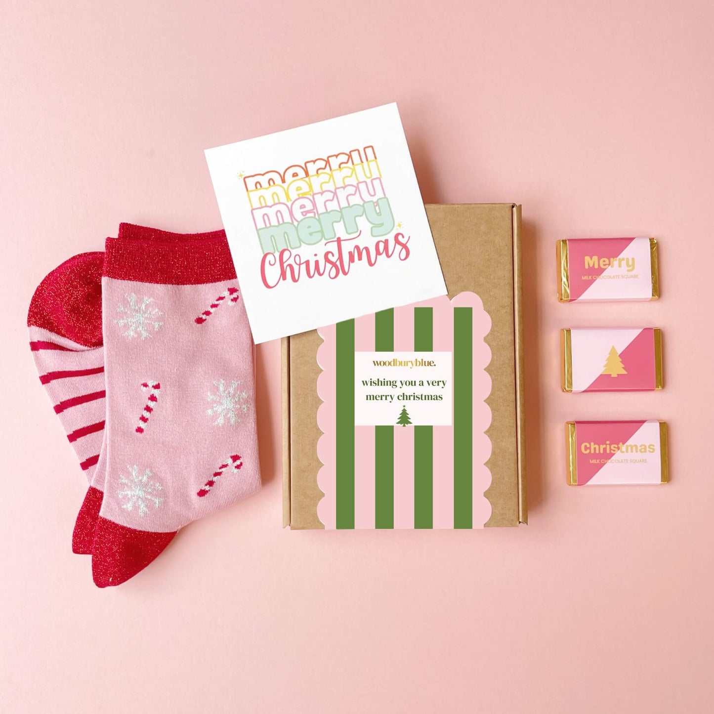 Pink Christmas letterbox gift box with festive socks, chocolates, and merry christmas notecard by Woodbury Blue