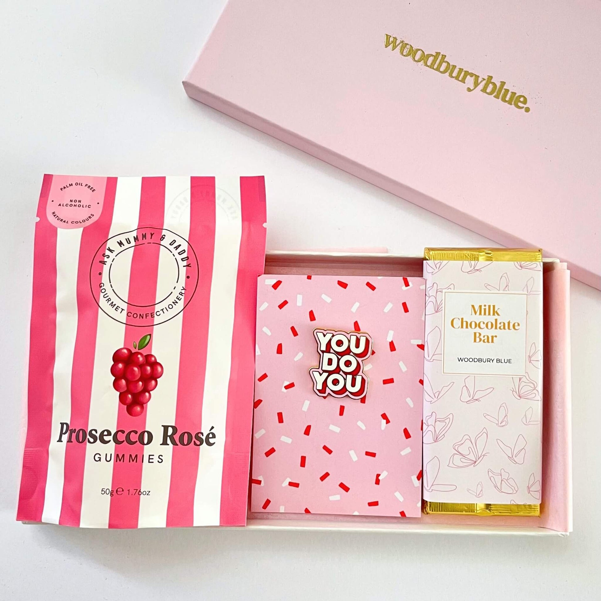 You do you letterbox gift set with prosecco rosé gummy sweets, you do you enamel pin badge and a milk chocolate bar