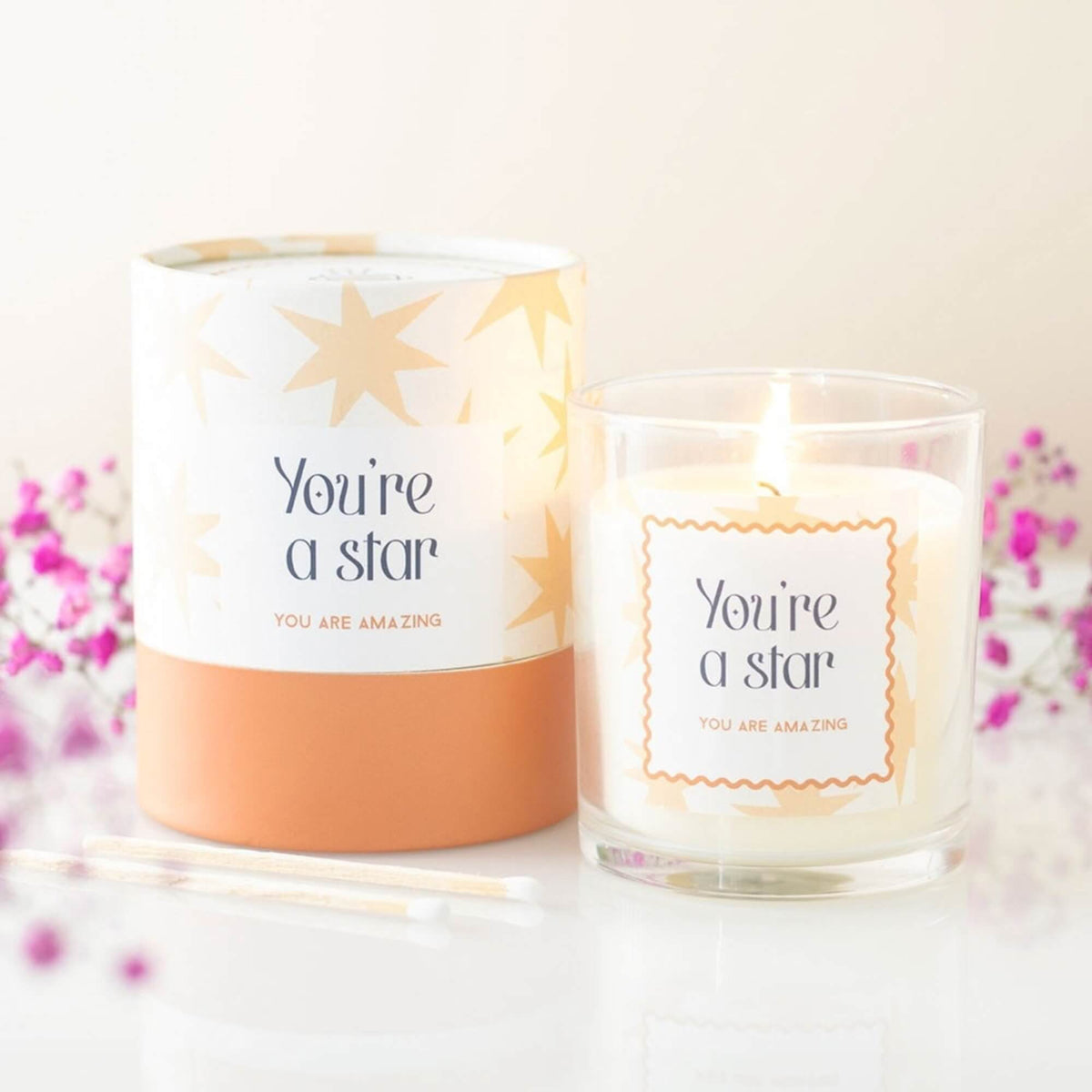 Lit You're a Star Salted Caramel scented candle beside its colourful gift tube